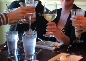 Group of tourists toasting at restaurant in St. Armands Circle, FL