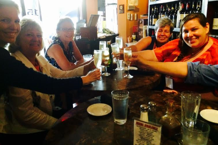 Group of tourists toasting drinks at 15 South Ristorante on St. Armands Circle