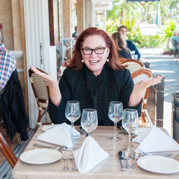 Susan Robinson, Owner of Key Culinary Tours posing at dinning table in Sarasota, FL