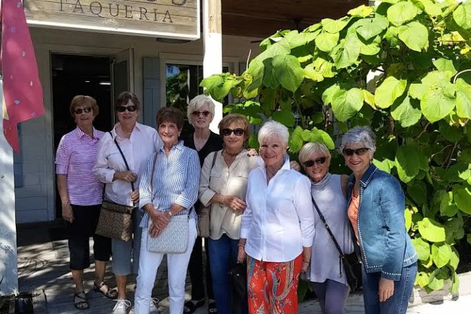 Group of tourists posing outside Poppo's Taqueria in Sarasota, FL
