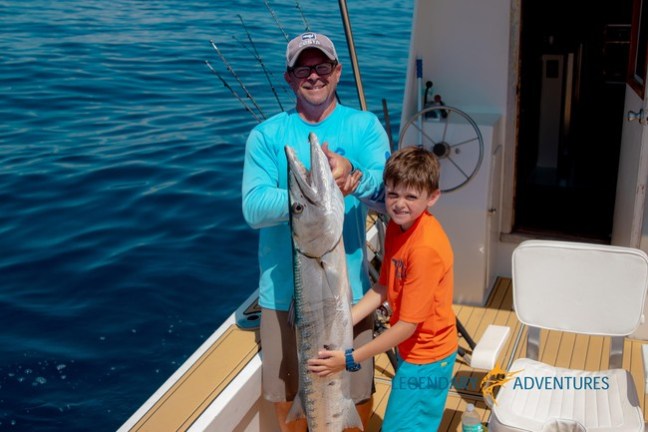 a person holding a fish in the water