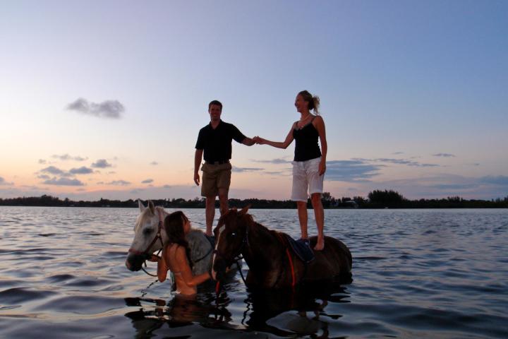 a person and a dog on a boat in the water