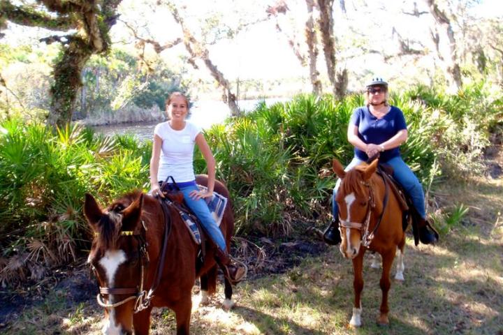 a group of people riding on the back of a horse