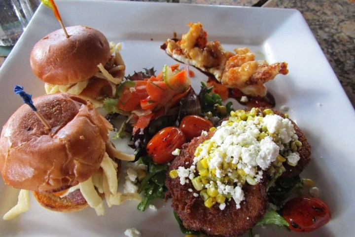 a plate of food with rice meat and vegetables