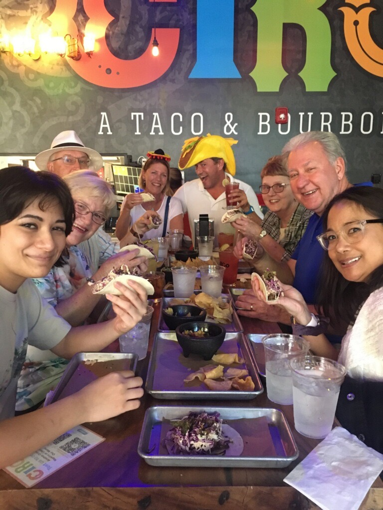 a group of people sitting at a table posing for the camera