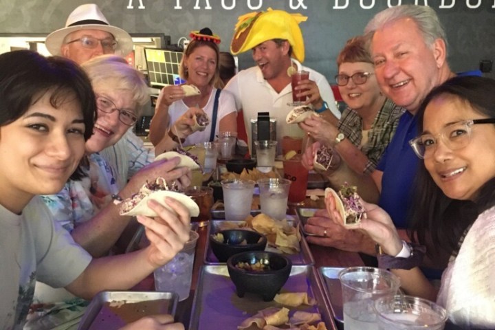 a group of people sitting at a table posing for the camera