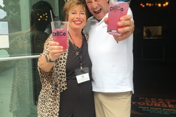a person holding a sign posing for the camera
