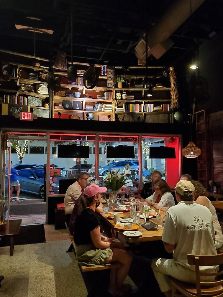 a group of people sitting at a table in a restaurant